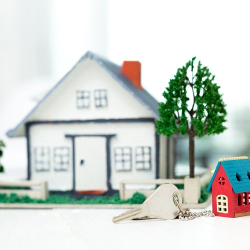 Real estate agent with house model and keys Real estate agent with house model and keys